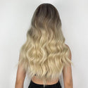 Back view of waist-length blonde wig showcasing natural shine