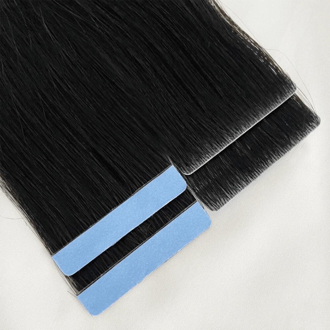 Black invisible tape in hair extensions with blue adhesive strips on a white background