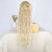 Blonde ponytail extension on a mannequin head with a plain background