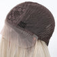Brown wig cap with lace front and blonde hair underneath on a white background