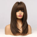 Brown wig with bangs on a mannequin head against a white background