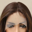 Close-up of a brown wig with a lace front on a neutral background