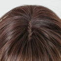 Close-up of brown wig with a white background