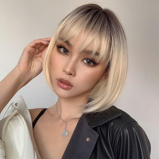 Front view of short blonde wig with bangs on model