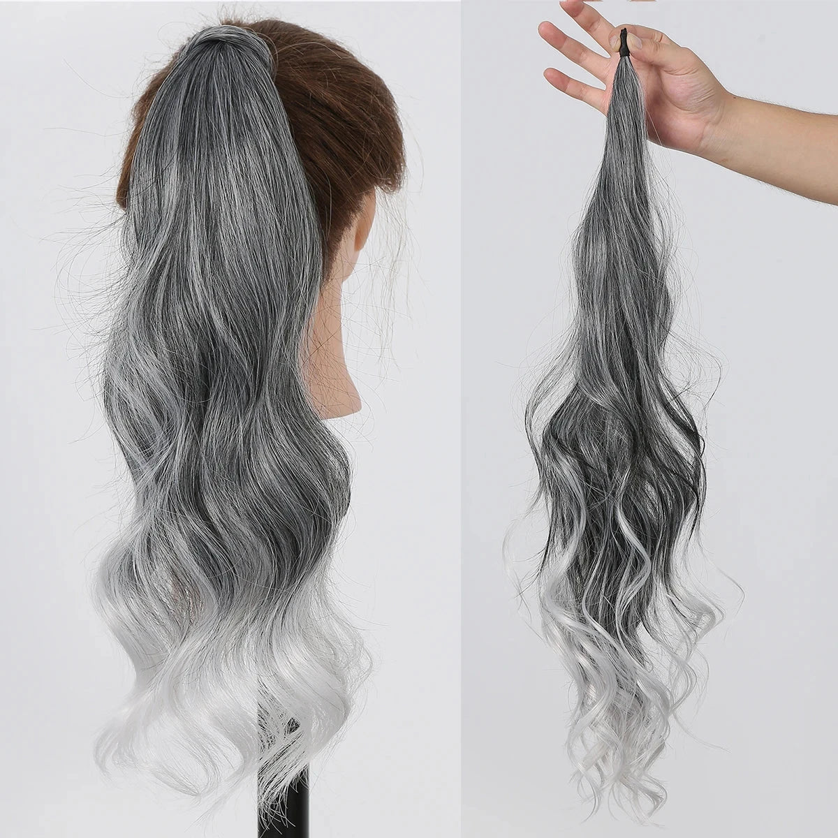 Gray hair ponytail extension on a mannequin head and held by a hand against a white background