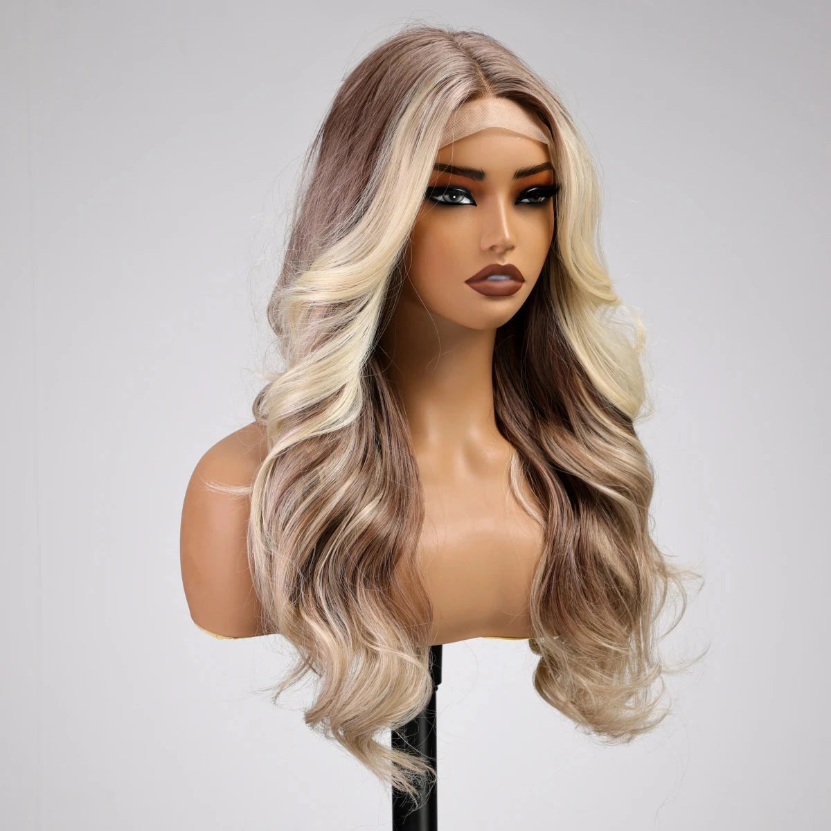 Mannequin head with a blonde and brown ombre wig on a gray background