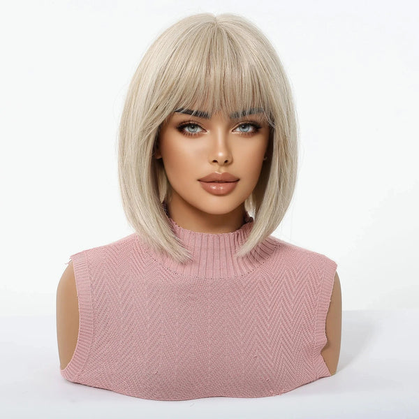 Mannequin head with a blonde wig with bangs and pink sleeveless top on a white background