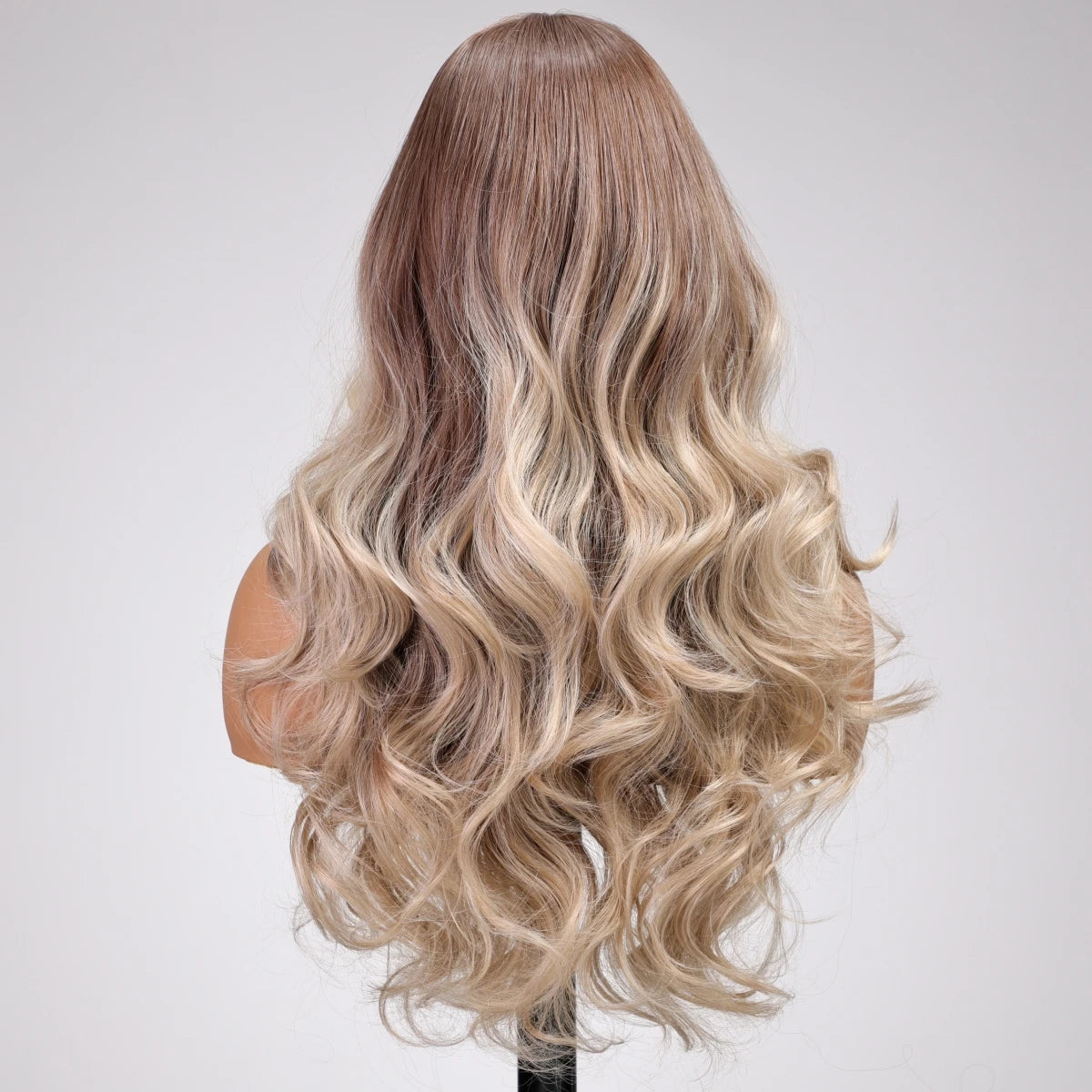 Mannequin head with long, wavy, blonde hair on a white background