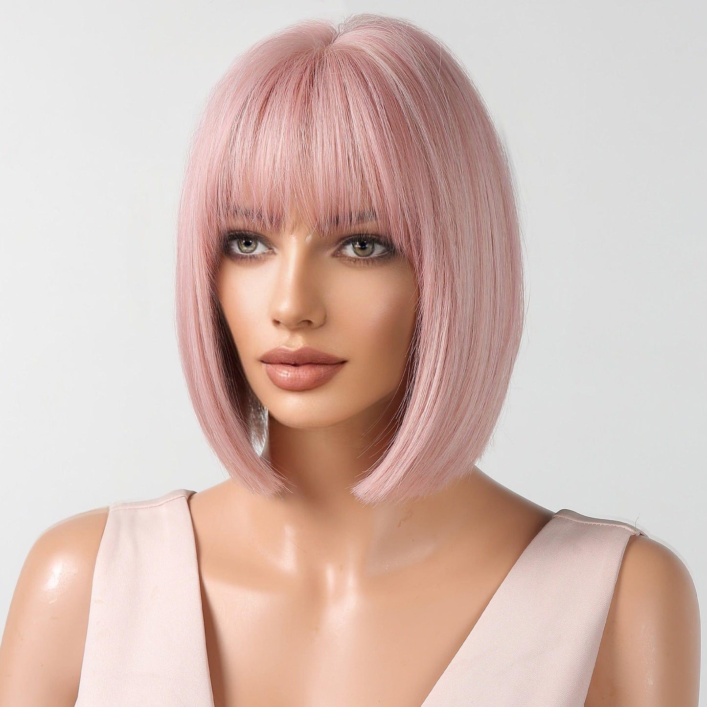 Mannequin head with pink bob wig on a white background