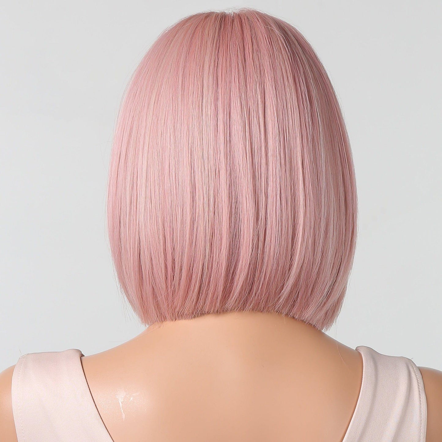 Mannequin head with pink straight hair on a light gray background