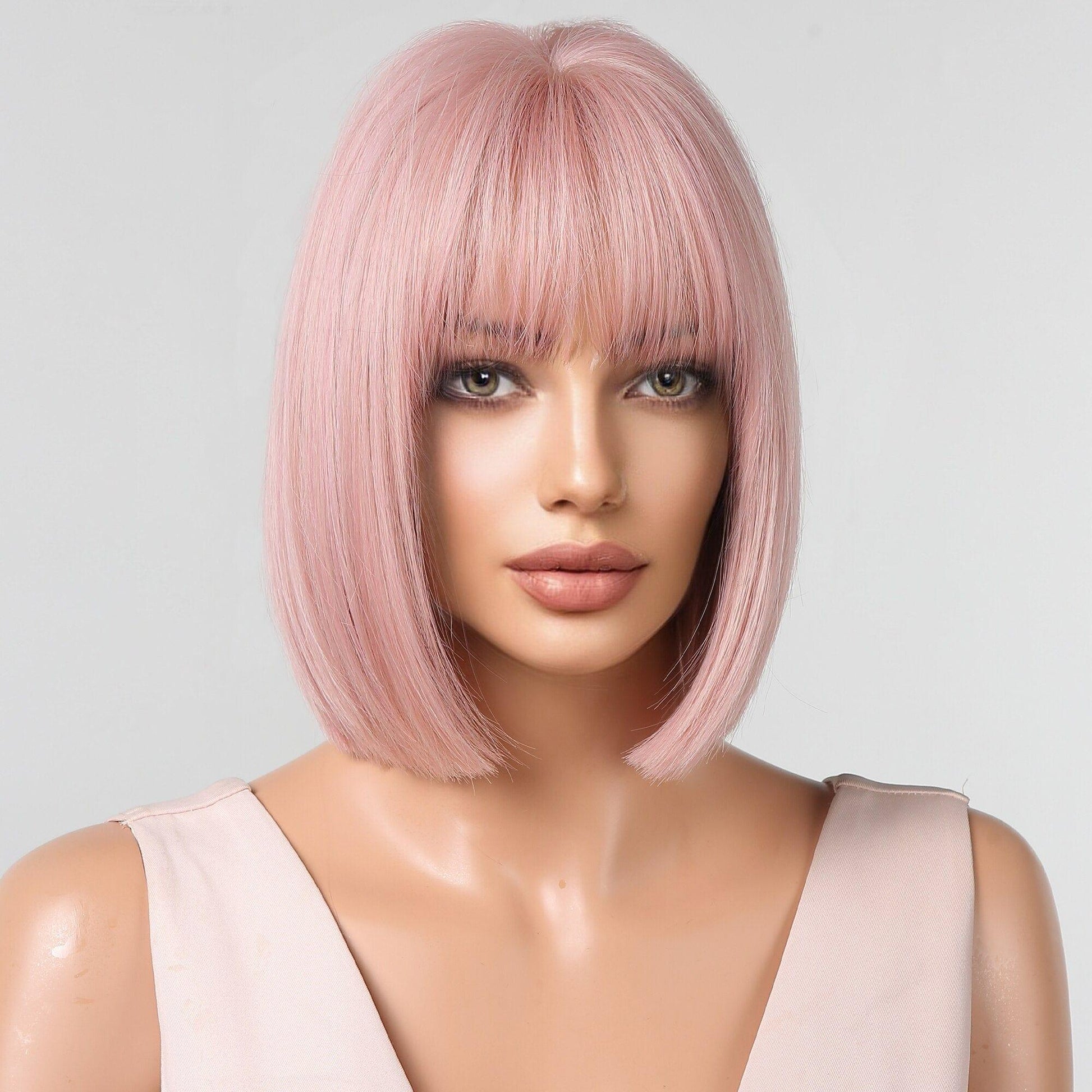 Mannequin head with short pink wig on a white background