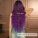 Person with purple wig showing hair length measurement, standing indoors.