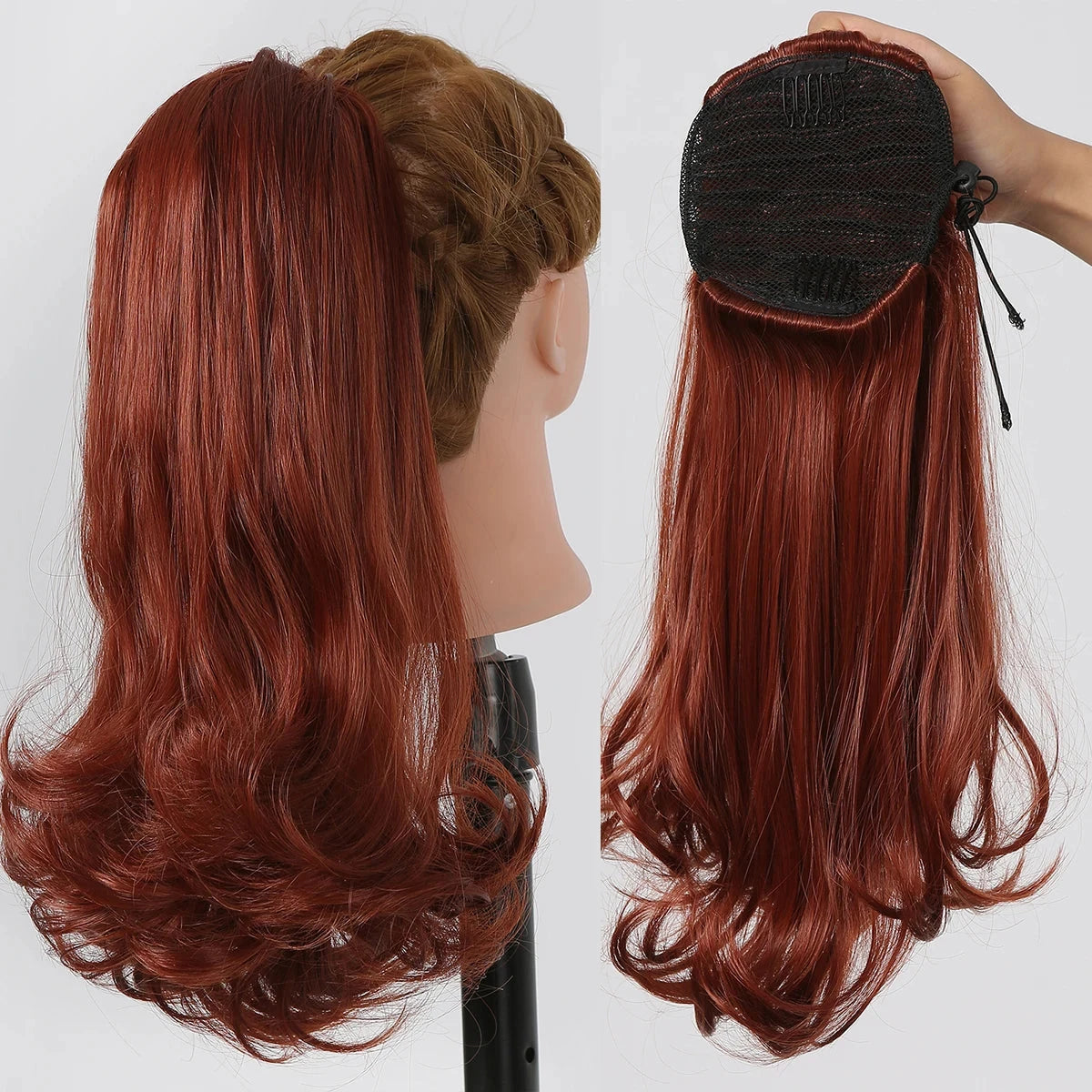 Red hair extension on a mannequin head and held by a hand against a white background