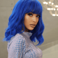 Side profile of vibrant blue wig showing wavy cut