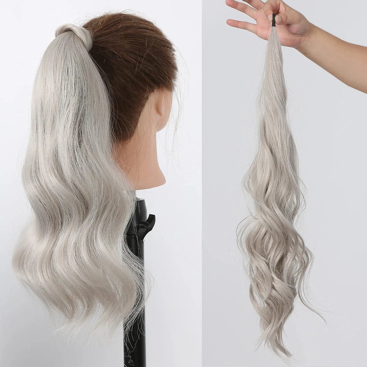 Silver hair ponytail extension on a mannequin head and held by a hand against a white background