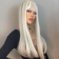Woman with long blonde wig against a neutral background