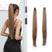 Woman with long brown ponytail and two hair extensions on a white background