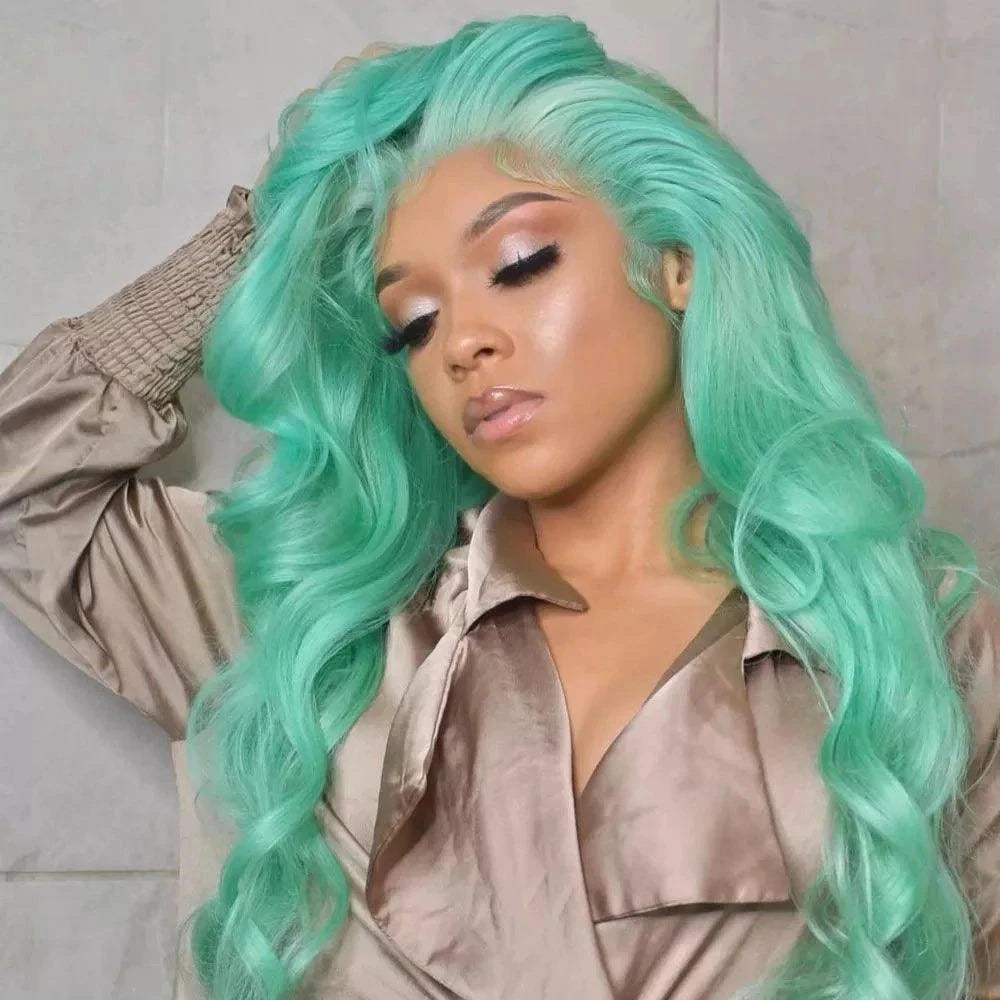 Woman with mint color wig wearing a beige outfit against a neutral background
